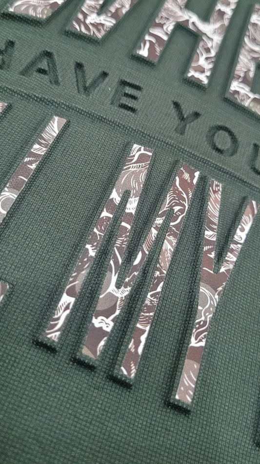 "Close-up of vacuum embossed lettering on premium plus-size party wear T-shirt – High-quality digital layer print for bold styling."