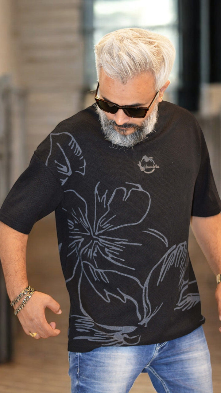 Side View: "Side profile of black oversized T-shirt – Relaxed fit with bold print and embossed detailing"
