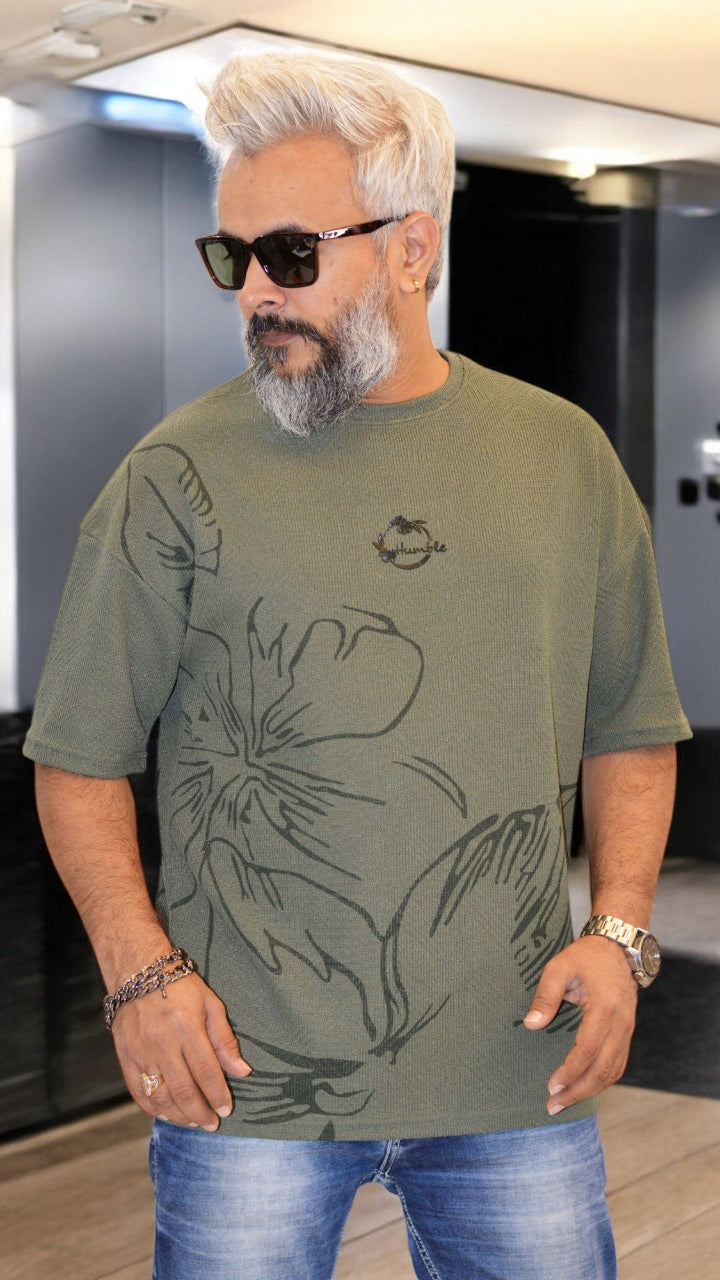 Front View: "Green oversized T-shirt with all-over print and silicone embossed 'Humble' – Stylish men's streetwear"
