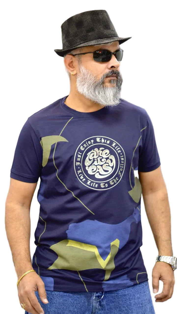 Man wearing a dark blue t-shirt with a logo and text, sunglasses, and a hat against a neutral background.