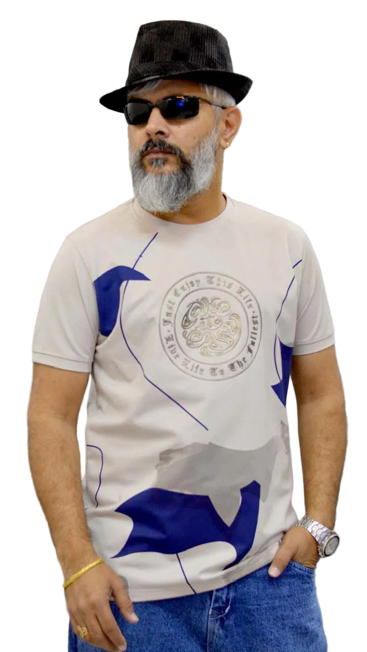Man wearing a white t-shirt with blue graphics, black hat, and sunglasses against a gray curtain background